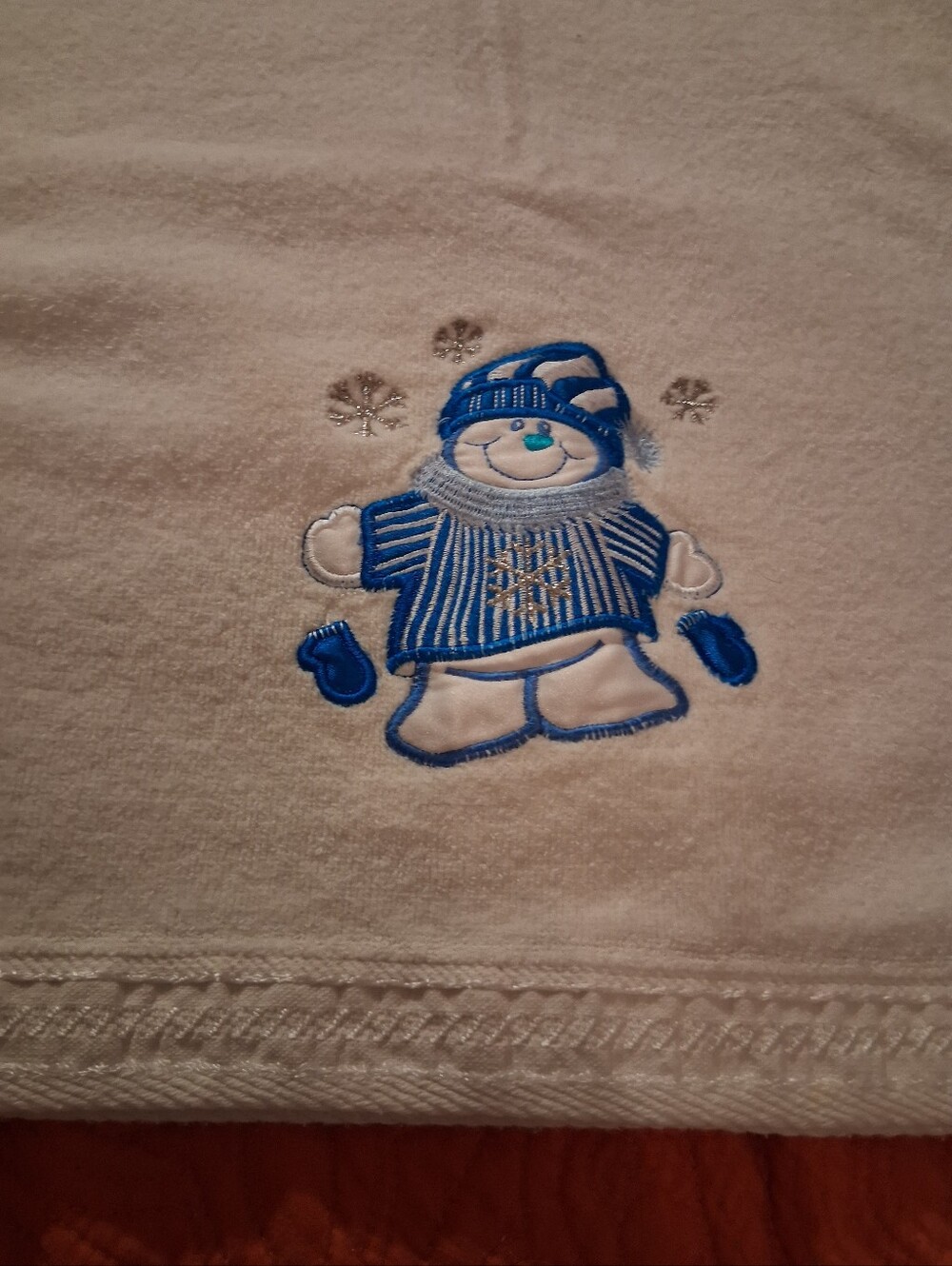 White Bath Towel With A Snowman Design On It